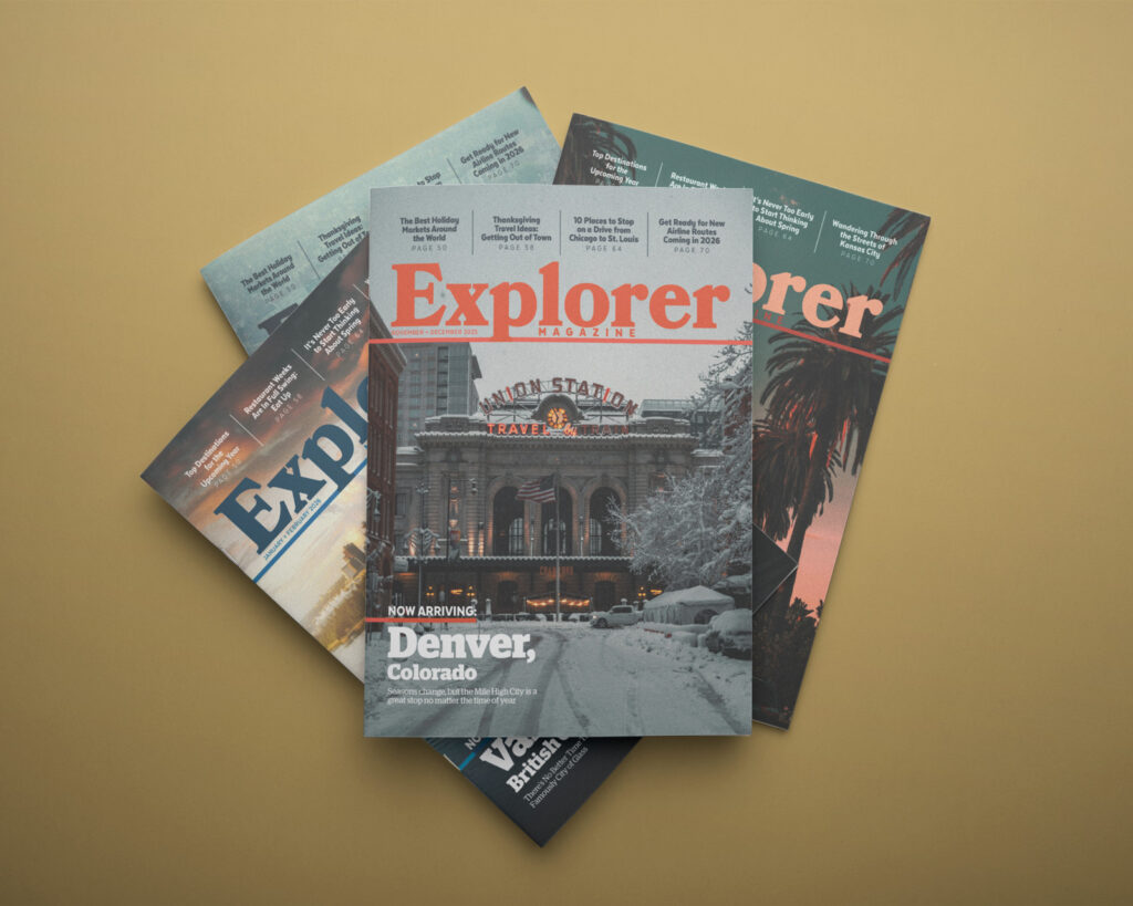 Four travel magazines stacked on each other.